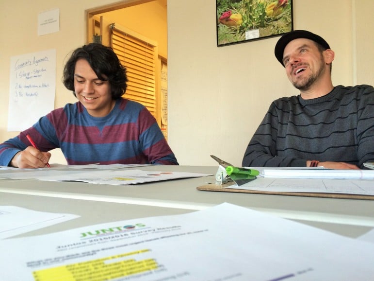 Robin Carreón (L) and Juntos Community Organizer, Michael Pitula, talk about the environmental group's work on climate change and air quality.