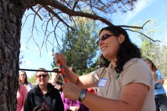 At the Sandia Mountain Natural History Center, Fiana Shapiro demonstrates how to produce an increment core from a ponderosa pine. 